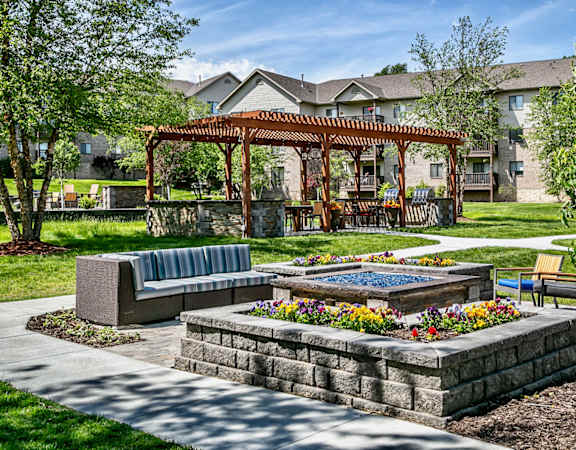 an outdoor patio with a fire pit and a gazebo