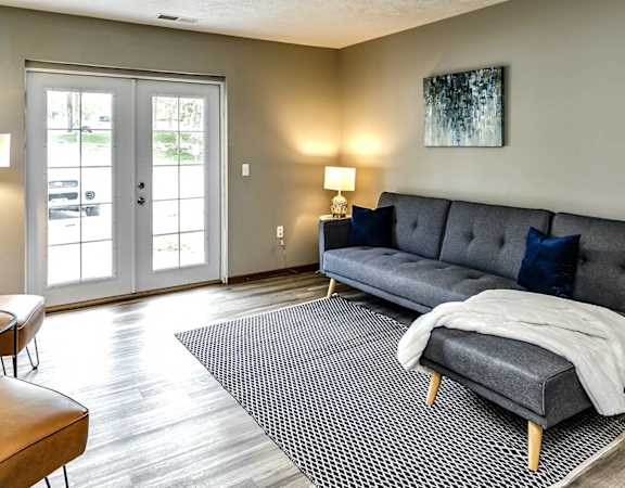 a living room with a couch and two doors