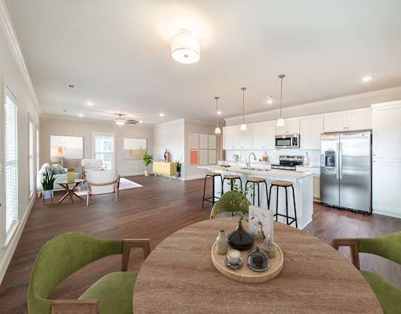 A modern kitchen with a dining table and chairs in the foreground.