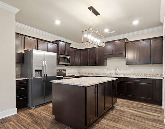 a kitchen with stainless steel appliances and a marble counter top