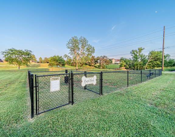 A fenced area with a sign that reads "Pet Park".