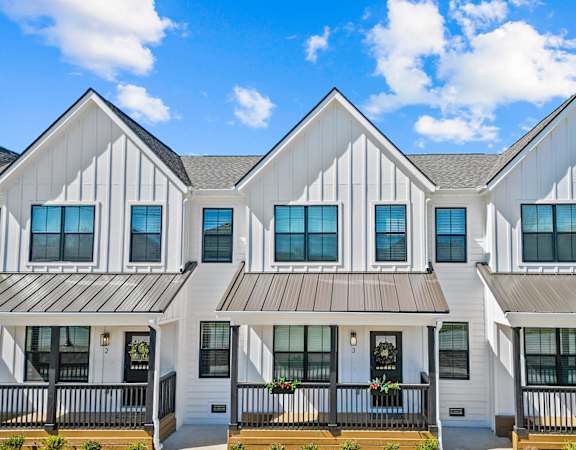 the view of a row of white houses with balconies
