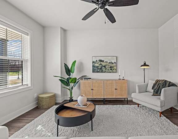 a living room with a ceiling fan and a couch