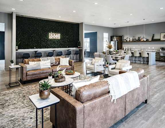 a large living room with couches and chairs and a bar