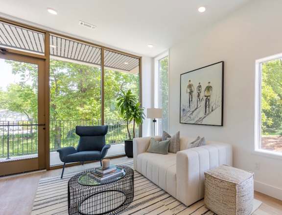 a living room with a white couch and a large window