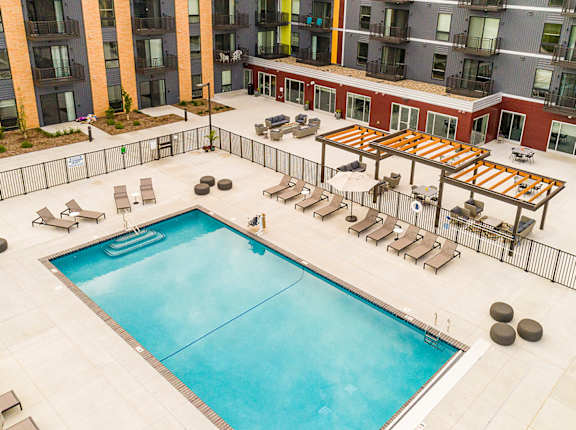an overhead view of a swimming pool and an apartment building
