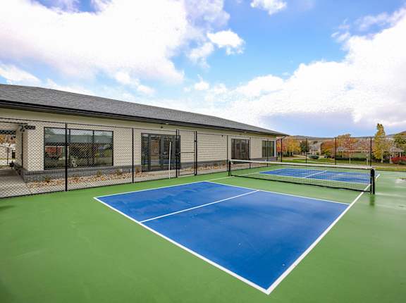 A tennis court with a blue surface and white lines.