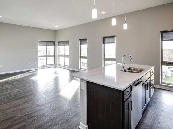 A kitchen with a large island and a dishwasher.