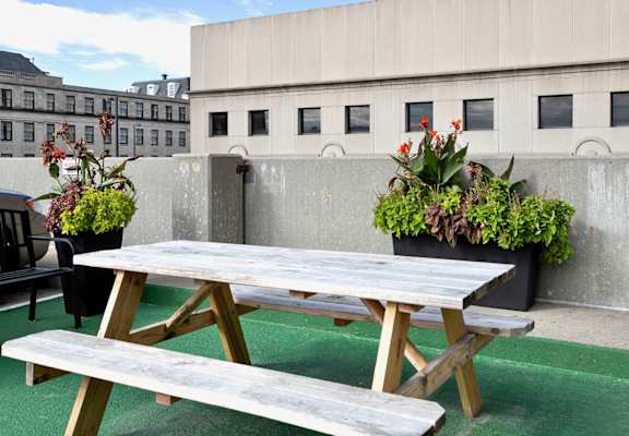 a picnic table and benches on a rooftop