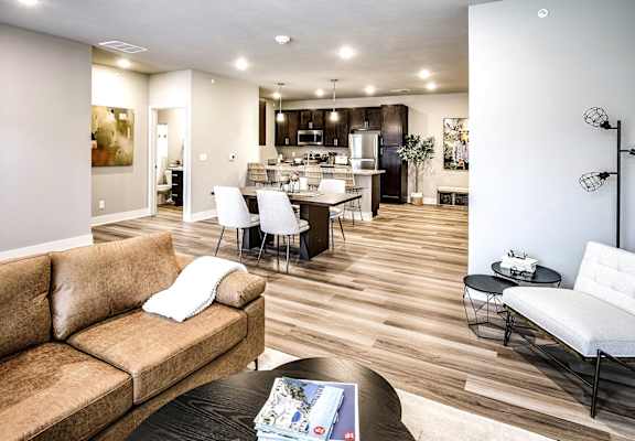 a living room and kitchen with a couch and a table