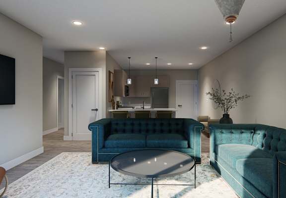 A living room with a blue couch and a glass coffee table.