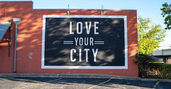 a mural on the side of a building that says love your city