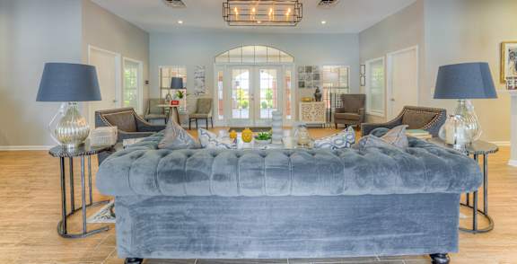 A large bedroom with a bed in the center and a chandelier hanging from the ceiling.