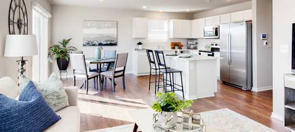 A modern kitchen with a dining table and chairs.