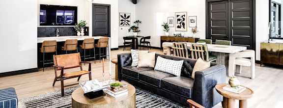 a living room with a couch and a table and a kitchen