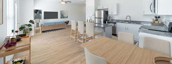 a living room with a dining room table and a kitchen