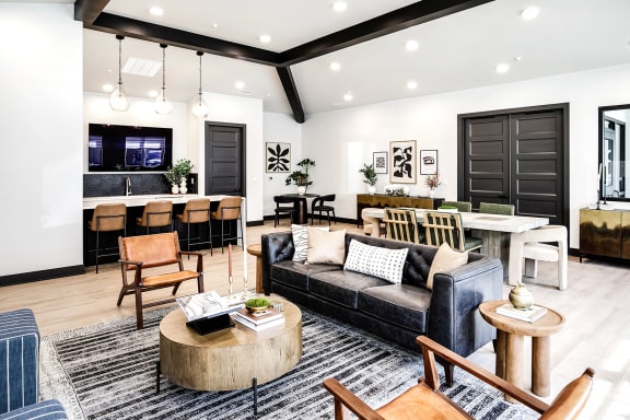 a living room with a couch and a table and a kitchen