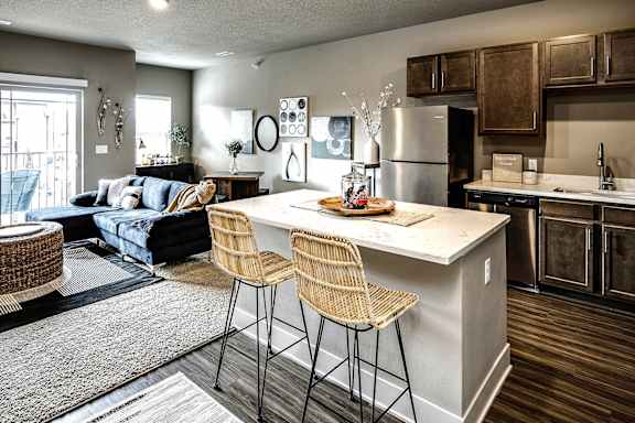 A kitchen with a bar stool and a countertop.