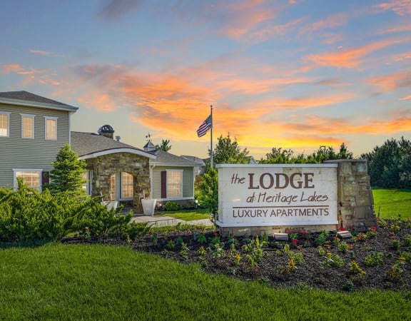 a home with a sign that reads the lodge of heritage lakes