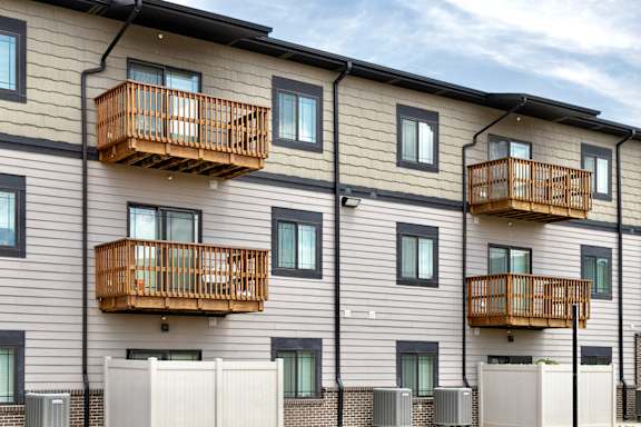 Apartment building with balconies and windows.