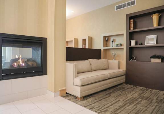 a living room with a fireplace and a couch at Cascades Overlook Apts., Owings Mills, 21117