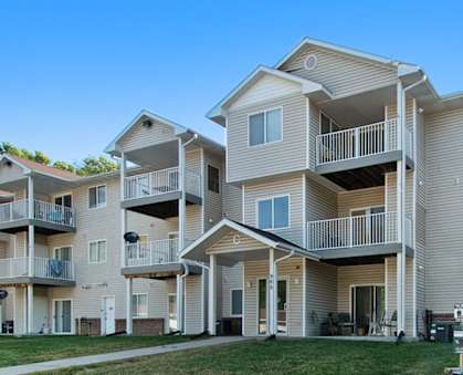Apartment complex with multiple balconies and doors.