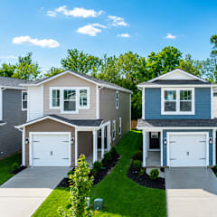 A row of houses with garages and driveways.
