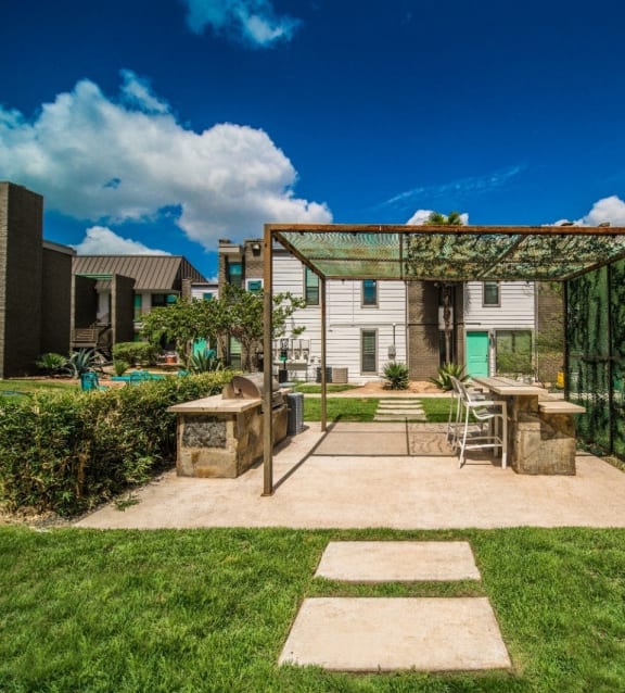 a backyard with a patio and a pergola