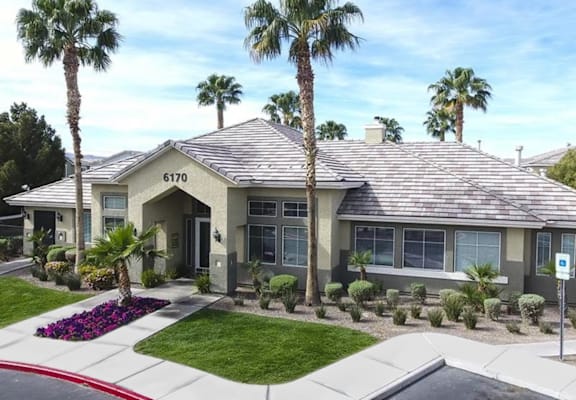 a house with palm trees in front of it  at Silver Creek Apartments, Las Vegas, NV