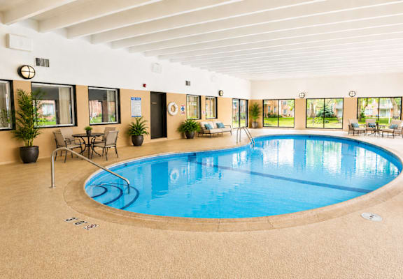 A large indoor swimming pool with a sunken seating area.