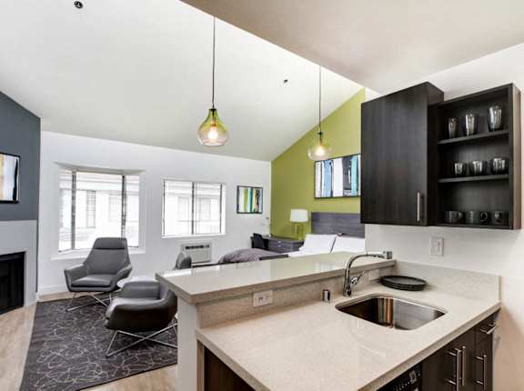 A kitchen with a fireplace and a counter with a sink at 1022 Tiverton, Los Angeles, CA