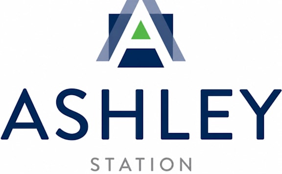 A logo with the text "ASHLEY STATION" in front of it.