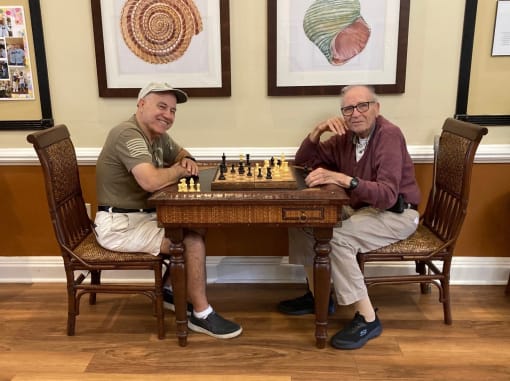 Residents Play Chess with Family Members at Elison Independent Living of Lake Worth