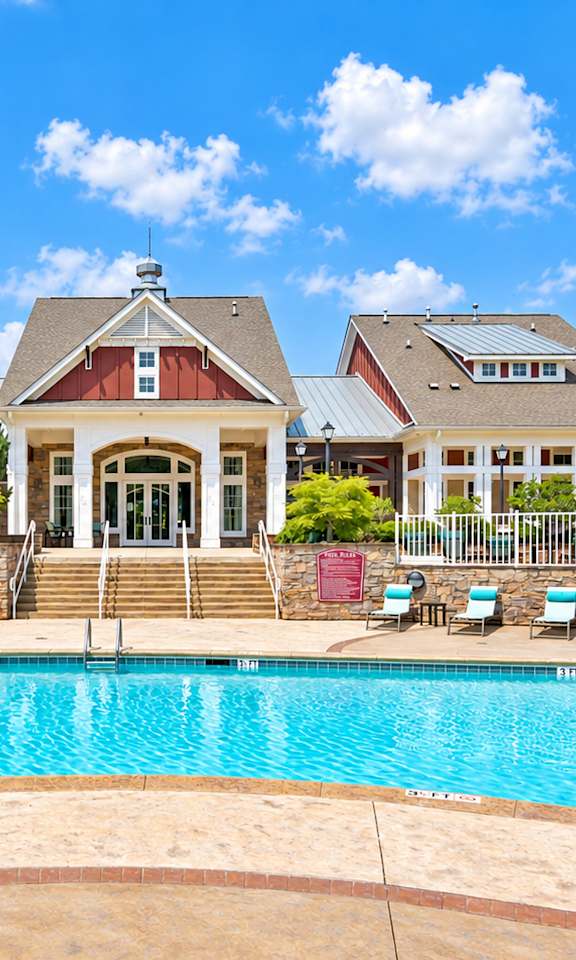 A large house with a pool in front.