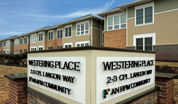 Exterior of building with sign that read "Westering Place: An RPM Community"