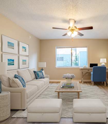 a furnished living room with a ceiling fan at Lago Bello Apartment