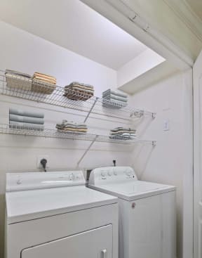 a laundry room with two washes and a dryer