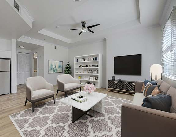 A living room with a brown couch, a white coffee table, and a ceiling fan.
