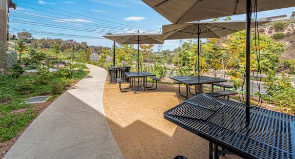 A sunny day at the outdoor seating area with tables and chairs.