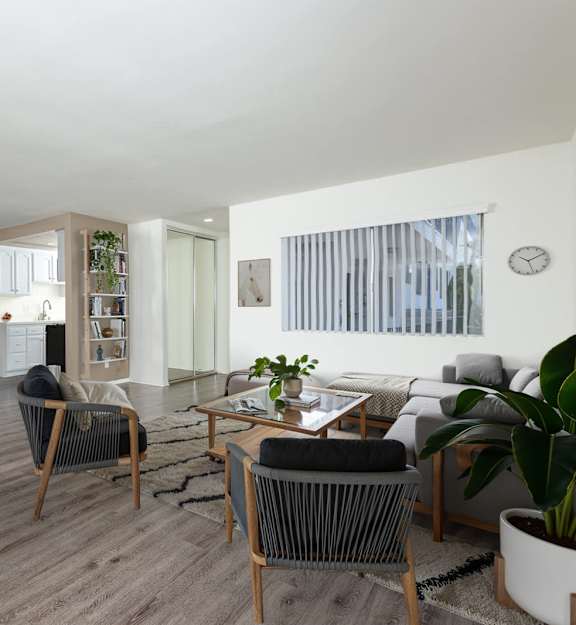 A living room with a grey sofa and a wooden coffee table.
