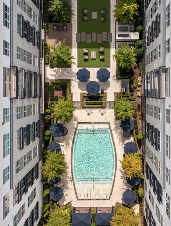 a bird's eye view of an apartment complex with a large swimming pool