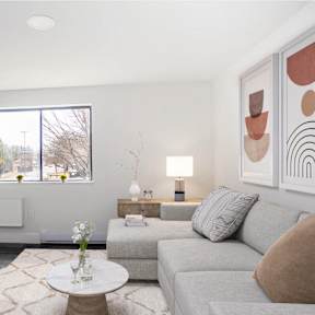 real estate photography of a living room with a couch and a tv
