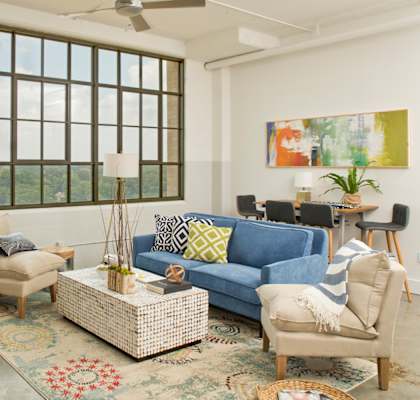 a living room with a blue couch and chairs at Parcels at Concourse, Memphis, 38104