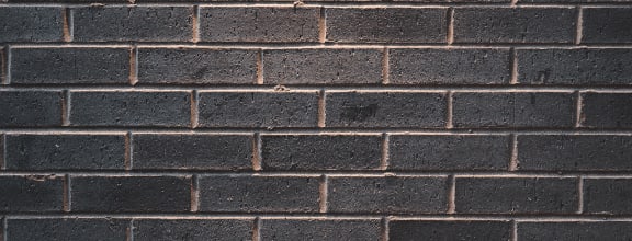 a close up of a black brick wall