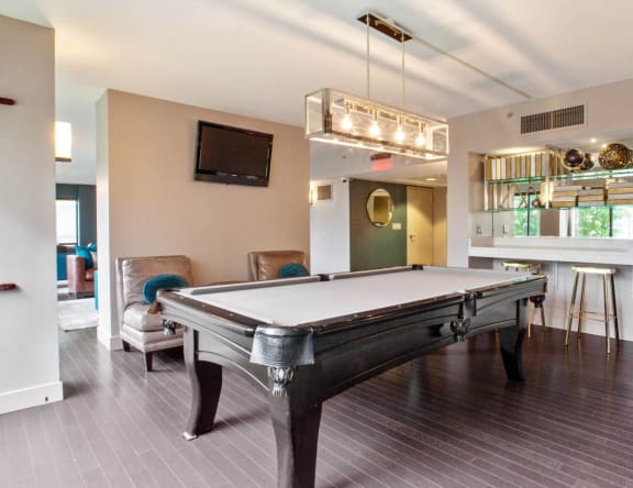 play a game of pool in our games room Prospect Place Apartments in Hackensack, NJ