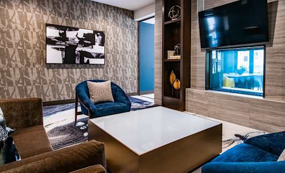 a living room with a table and chairs and a television at 44 Washington, Kansas City, MO