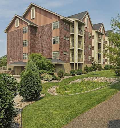 A red brick apartment building with a lamp post in front of it at The Gables at Park Pointe, St. Louis Park, 55426.