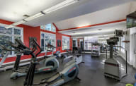 A gym with a variety of exercise equipment including treadmills, stationary bikes, and elliptical machines. at The Township, Missouri