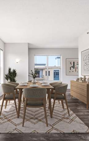A dining room with a table set for four.