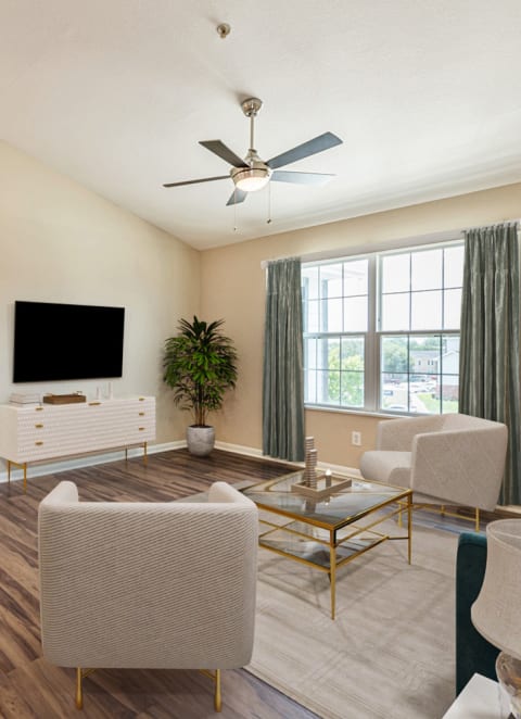 a living room with furniture and a ceiling fan at Vermillion Apartments, Houston Texas
